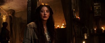 Movie still from “The Dark Tower” (2017), directed by Nikolaj Arcel – A beautiful young woman with long hair wearing a necklace; Close Up shot, Over the shoulder angle