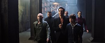 Movie still from “The Dark Tower” (2017), directed by Nikolaj Arcel – A group of men walking down a street; Medium shot, Low angle