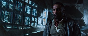 Movie still from “The Dark Tower” (2017), directed by Nikolaj Arcel – A man standing in front of a window in a dark room; Close Up shot, Low angle