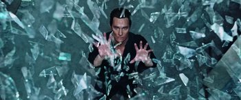 Movie still from “The Dark Tower” (2017), directed by Nikolaj Arcel – A man in black shirt surrounded by shattered glass; Medium shot, Low angle