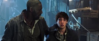 Movie still from “The Dark Tower” (2017), directed by Nikolaj Arcel – A man standing next to another man in a room; Close Up shot, Over the shoulder angle