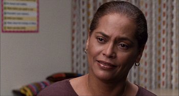 Movie still from “Choke” (2008), directed by Clark Gregg – A person wearing a purple shirt; Close Up shot, Over the shoulder angle