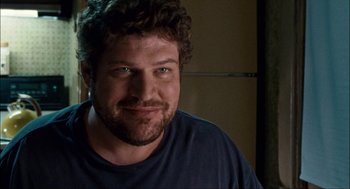 Movie still from “Choke” (2008), directed by Clark Gregg – A person with curly hair; Close Up shot, Over the shoulder angle