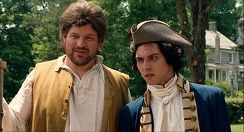Movie still from “Choke” (2008), directed by Clark Gregg – A man and a man in a pirate costume; Medium shot, Low angle