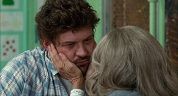 Movie still from “Choke” (2008), directed by Clark Gregg – A man and a woman are kissing in a room; Close Up shot, Over the shoulder angle