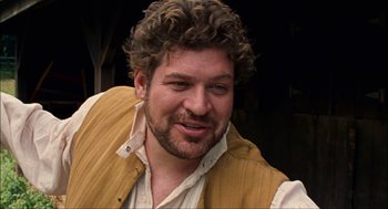 Movie still from “Choke” (2008), directed by Clark Gregg – A person with curly hair and a beard; Close Up shot, Over the shoulder angle