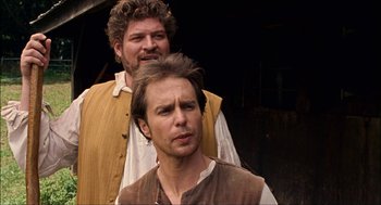 Movie still from “Choke” (2008), directed by Clark Gregg – Two men standing next to each other wearing medieval clothing; Close Up shot, Over the shoulder angle