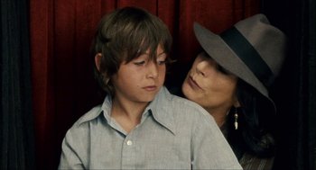 Movie still from “Choke” (2008), directed by Clark Gregg – A woman and a young boy sitting next to each other; Close Up shot, Over the shoulder angle