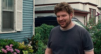 Movie still from “Choke” (2008), directed by Clark Gregg – A man standing in front of a house; Close Up shot, Over the shoulder angle