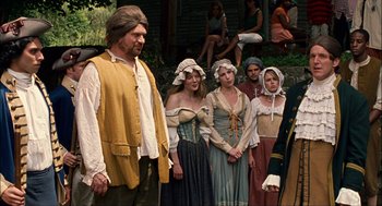 Movie still from “Choke” (2008), directed by Clark Gregg – A group of people dressed in period clothing; Medium shot, Over the shoulder angle