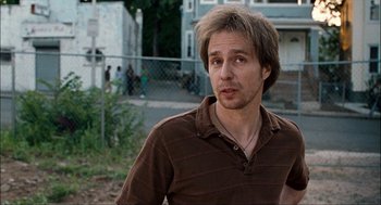 Movie still from “Choke” (2008), directed by Clark Gregg – A person wearing a brown shirt; Close Up shot, Over the shoulder angle