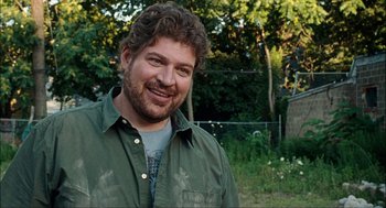 Movie still from “Choke” (2008), directed by Clark Gregg – A person wearing a green shirt; Close Up shot, Over the shoulder angle