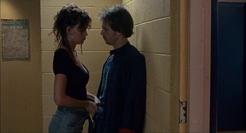 Movie still from “Choke” (2008), directed by Clark Gregg – A man and a woman standing next to each other; Medium shot, Over the shoulder angle