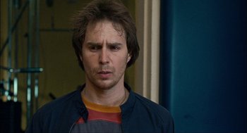 Movie still from “Choke” (2008), directed by Clark Gregg – A person wearing a jacket; Close Up shot, Over the shoulder angle