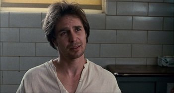 Movie still from “Choke” (2008), directed by Clark Gregg – A person wearing a white shirt; Close Up shot, Over the shoulder angle