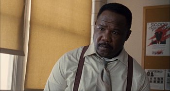 Movie still from “Choke” (2008), directed by Clark Gregg – A man in a dress shirt and a tie; Close Up shot, Low angle