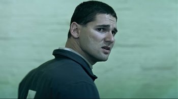 Movie still from “Chopper” (2000), directed by Andrew Dominik – A person wearing a jacket; Close Up shot, Low angle