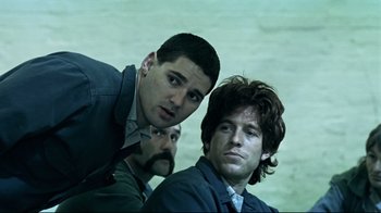 Movie still from “Chopper” (2000), directed by Andrew Dominik – A group of men standing next to each other; Medium shot, Low angle