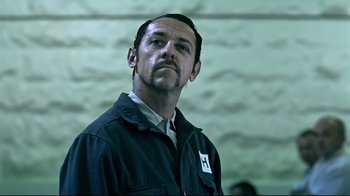 Movie still from “Chopper” (2000), directed by Andrew Dominik – A person wearing a jacket; Close Up shot, Low angle