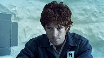 Movie still from “Chopper” (2000), directed by Andrew Dominik – A man with red hair is wearing a blue jacket; Close Up shot, Low angle