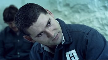 Movie still from “Chopper” (2000), directed by Andrew Dominik – A person wearing a jacket; Close Up shot, Over the shoulder angle