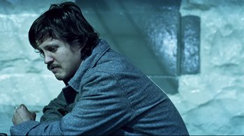 Movie still from “Chopper” (2000), directed by Andrew Dominik – A man in a jacket and tie looking down; Close Up shot, Low angle