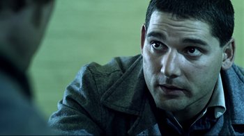 Movie still from “Chopper” (2000), directed by Andrew Dominik – A person wearing a jacket; Close Up shot, Over the shoulder angle