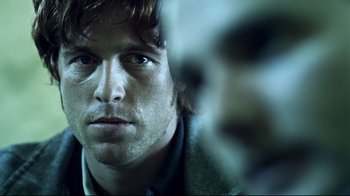 Movie still from “Chopper” (2000), directed by Andrew Dominik – A man's face in front of a mirror; Close Up shot, Over the shoulder angle