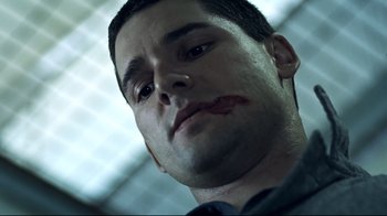 Movie still from “Chopper” (2000), directed by Andrew Dominik – A person with blood on his face; Close Up shot, Low angle