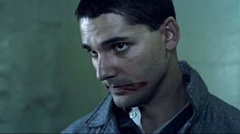 Movie still from “Chopper” (2000), directed by Andrew Dominik – A person wearing a shirt and jacket; Close Up shot, Low angle