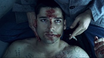 Movie still from “Chopper” (2000), directed by Andrew Dominik – A man with blood all over his face; Close Up shot, Overhead angle