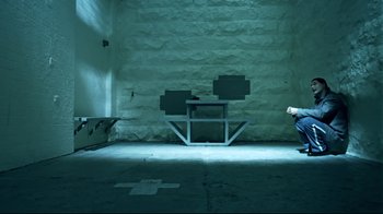 Movie still from “Chopper” (2000), directed by Andrew Dominik – A room that has a table in the middle of the floor; Wide shot, High angle