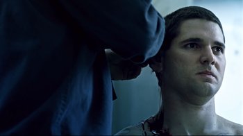 Movie still from “Chopper” (2000), directed by Andrew Dominik – A man getting his hair cut by a barber; Close Up shot, Over the shoulder angle