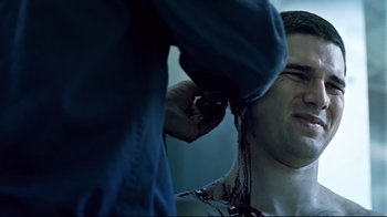 Movie still from “Chopper” (2000), directed by Andrew Dominik – A man with blood all over his face and neck; Close Up shot, Over the shoulder angle