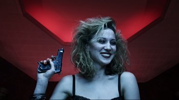 Movie still from “Chopper” (2000), directed by Andrew Dominik – A woman holding a gun in her hand; Close Up shot, Overhead angle