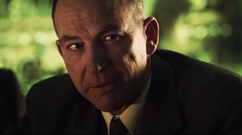 Movie still from “Chopper” (2000), directed by Andrew Dominik – A person wearing a suit and tie; Close Up shot, Low angle