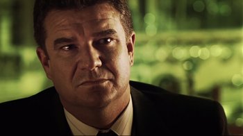 Movie still from “Chopper” (2000), directed by Andrew Dominik – A person wearing a suit and tie; Close Up shot, Low angle