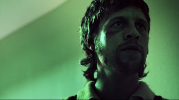 Movie still from “Chopper” (2000), directed by Andrew Dominik – A person with long hair; Close Up shot, Low angle