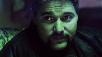 Movie still from “Chopper” (2000), directed by Andrew Dominik – A person with a mustache; Close Up shot, Over the shoulder angle
