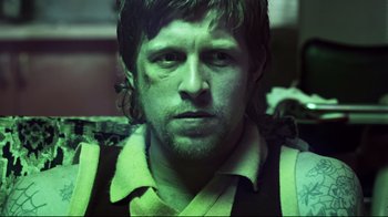 Movie still from “Chopper” (2000), directed by Andrew Dominik – A person wearing a shirt; Close Up shot, Low angle