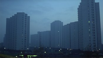 Movie still from “Christiane F.” (1981), directed by Uli Edel – A view of a city skyline at night; Extreme Wide shot, High angle
