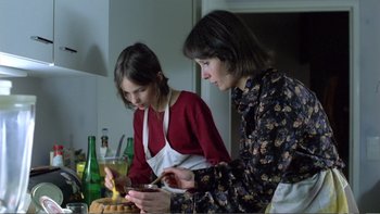 Movie still from “Christiane F.” (1981), directed by Uli Edel – Two women are preparing food in the kitchen; Medium shot, High angle