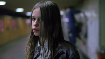 Movie still from “Christiane F.” (1981), directed by Uli Edel – A girl with long hair is looking at the camera; Close Up shot, Low angle