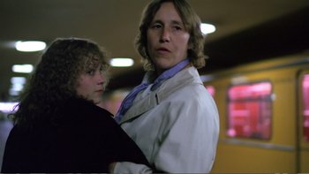 Movie still from “Christiane F.” (1981), directed by Uli Edel – A man and a woman standing next to each other; Close Up shot, Low angle