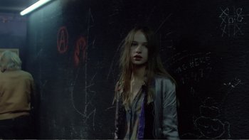 Movie still from “Christiane F.” (1981), directed by Uli Edel – A woman standing in front of a wall with graffiti on it; Medium shot, Low angle