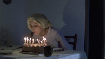 Movie still from “Christiane F.” (1981), directed by Uli Edel – A woman blowing out candles on a cake; Medium shot, High angle