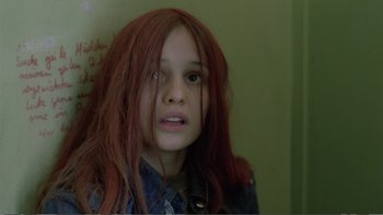 Movie still from “Christiane F.” (1981), directed by Uli Edel – A young girl with red hair looking at the camera; Close Up shot, High angle