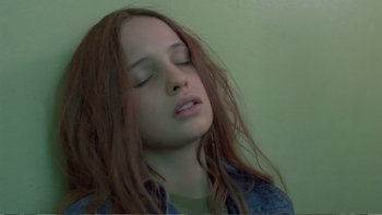 Movie still from “Christiane F.” (1981), directed by Uli Edel – A woman with long red hair is sleeping; Close Up shot, Overhead angle