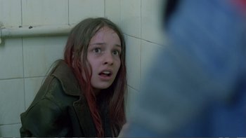 Movie still from “Christiane F.” (1981), directed by Uli Edel – A young girl with red hair looking into a mirror; Close Up shot, Over the shoulder angle