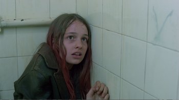 Movie still from “Christiane F.” (1981), directed by Uli Edel – A young girl leaning against a wall in a bathroom; Close Up shot, High angle